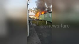 Huge caravan fire caused by 'faulty charger' breaks out at Welsh holiday park