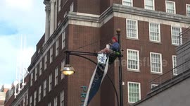 Man climbs lamppost in London's Oxford Street in climate change protest