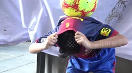 Young Thai boy wearing a Messi top shows off his impressive football freestyle skills