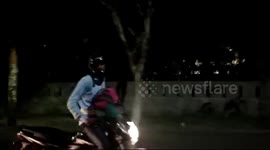Man sits upright on his motorbike to stop his tyre from deflating