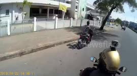 Bungling crook sparks police motorcycle chase but hits and curb and goes head over handlebars
