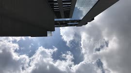time lapse looking up skyscraper clouds moving