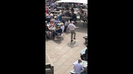 Having the time of his life! Elderly man dances in front of crowd in beer garden