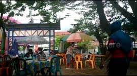 Scared stall-holders batten down the hatches during high winds in Indonesia