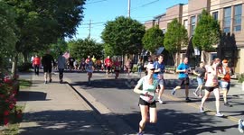 runner with American flag passes by during a marathon, patriotic!!