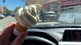 dangerous summer driver with ice cream in hand