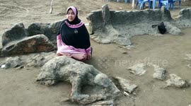 People visit 'cursed man' statue tourist landmark in eastern Indonesia