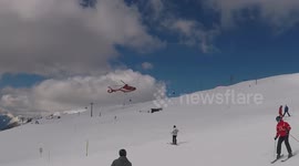 Rescue Air Ambulance helicopter seen landing on mountain in Switzerland