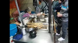 Jeju Korea street food - lady making sugar fried rice cakes