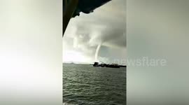 Large waterspout swirls through the sea off Thai island
