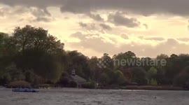 Dramatic sunset over the Serpentine lake in Hyde Park on a windy night in spring - London