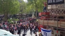 Ajax ultra climbs scaffolding and leads chants at Leicester Square in London