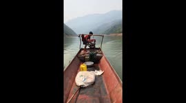 The ten-year-old boy controls the boat on the river professionally