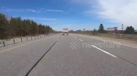 Cars and trucks driving on Ontario highway POV