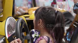 Asian cute girl is playing toy car.