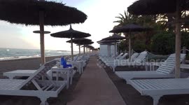 sunset on the beach drone flying through parasols no people summer vacation vibes