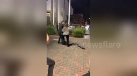 Furious woman finds lost boyfriend skateboarding and pushes him to the ground