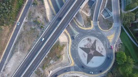 birds eye view of roads and roundabout with cars driving