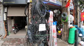 Strange and dangerous electric poles - A typical tangled mass of power lines in Vietnam