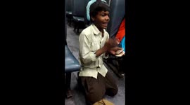 10 year old child using stones as instrument and singing song very nicely and in a running train very fluently and gets rewarded for it