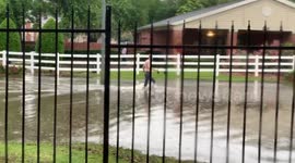Man Walks through high water in Houston