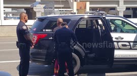 Woman being arrested us customs call inLAX airport police for allegedly Assault on a cop in Alaska