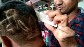 Watch - A supporter of Indian Prime Minister Narendra Modi gets a haircut of his name in Bikaner .