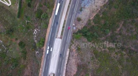 drone footage of highway with cars traveling on it fast, birds eye view