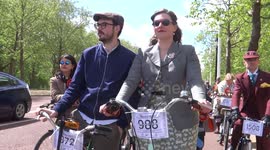 Scores of people ride through London dressed in tweed