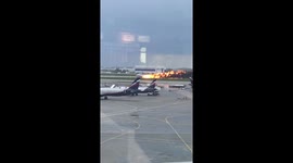 This is the moment a plane engulfed in flames crash lands at an airport in Moscow