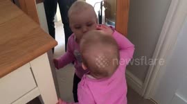Cute baby kissing mirror reflection