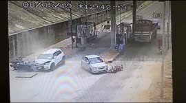 Car speeds through Indian toll booth and crashes into car and motorcycles