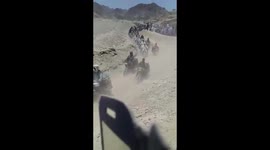 Huge line of fuel smugglers cross the border from Iran into Pakistan
