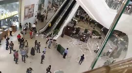 Debris plunges from fifth floor escalator as heavy rain batters Philippines shopping mall