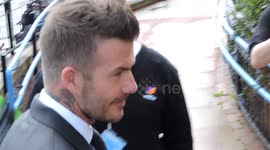 David Beckham arrives at court in London to swarm of photographers