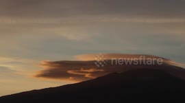 Impressive timelapse of lenticular clouds flowing over Mount Etna during sunset