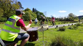 Jazz drummer entertains cyclist taking part in the Fred Whitton Challenge in The Lake District, England