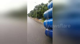 Wide load! Man seen carrying 10 metal barrels on back of his scooter