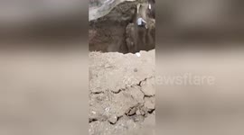 Chinese man luckily survives fall into river after bank collapses under him