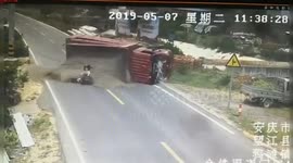 Transport truck flips over trying to avoid scooter riders, only to bury them in sand