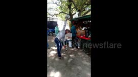 Skilled fruit juice seller pours drink from a height without spilling a drop