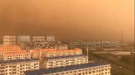 Sky turns orange in Chinese town after cold winds carry dust in air