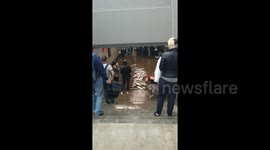 Russian commuters wade through flooded station in Moscow
