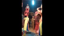Woman in Vietnam uses her mouth to lift a child and chair over her head