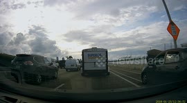 Car in Miami drives down bike lane despite hood up blocking driver's view