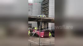 Delivery lorry left overturned after crashing through flyover barrier in Reading