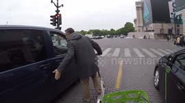 (GoPro dashcam) Road rage in Paris.Man trying to open the door of an automobilist.  A man on a electric dockless scooter is angry after having been honked. 17 may 2019.