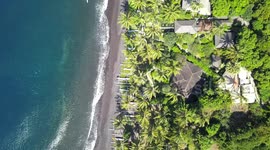 2.7k Steady Aerial View of the Coastline & Waves Tulamben Beach with traditional Jukung Boats