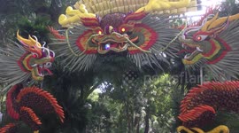 The large gate is made of flowers and fruits with strange animal shapes