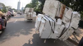 Ridiculous overloaded bikes carrying many foam boxes two stories high and bulky on the road are very dangerous